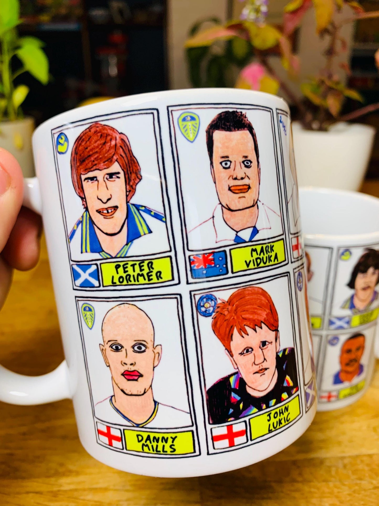 Leeds United Vol 1 No Score Draws Mug Set - Set of TWO 11oz Ceramic Mugs with Wonky Panini-style No Score Draws Doodles of LUFC legends