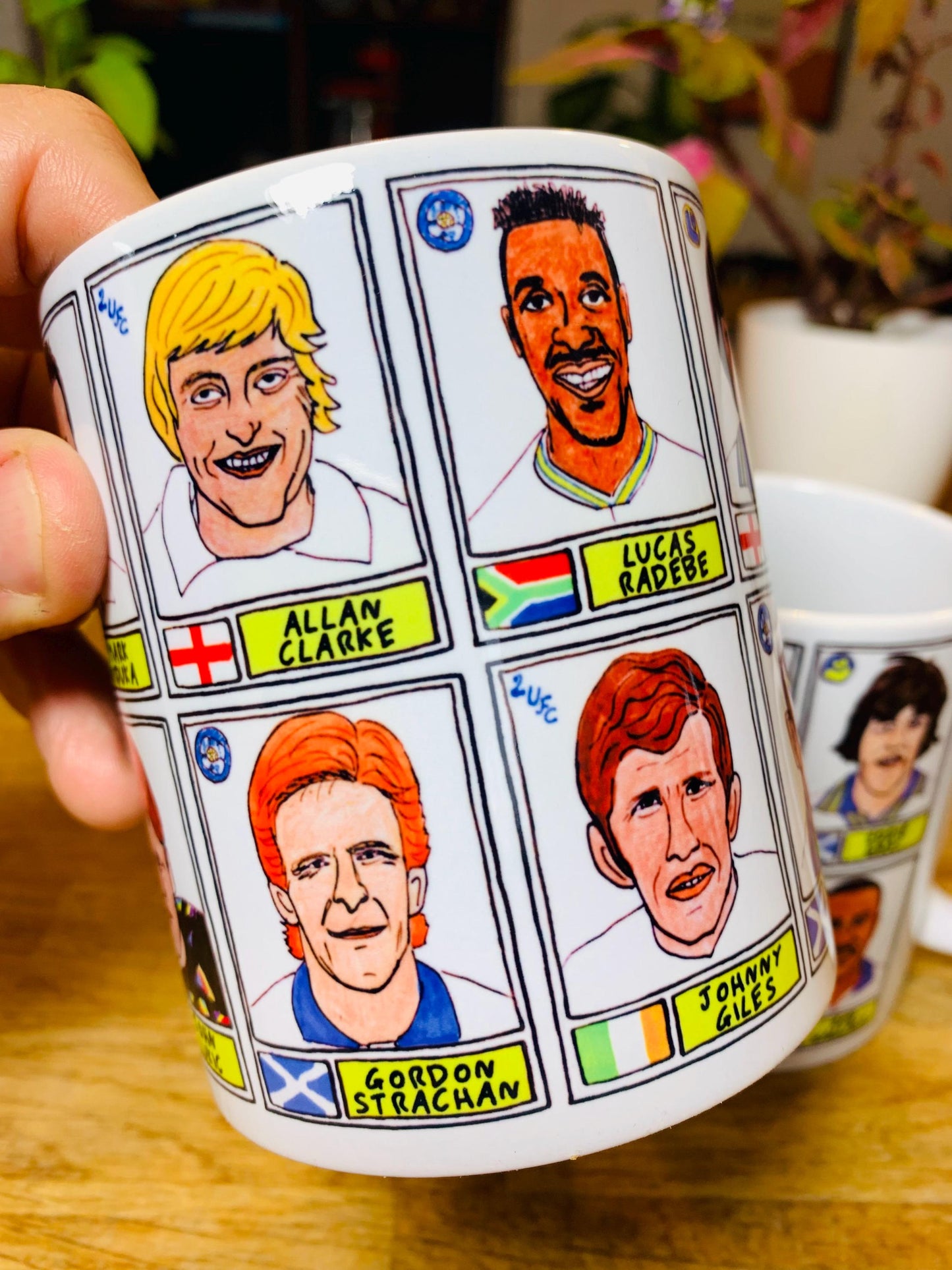 Leeds United Vol 1 No Score Draws Mug Set - Set of TWO 11oz Ceramic Mugs with Wonky Panini-style No Score Draws Doodles of LUFC legends