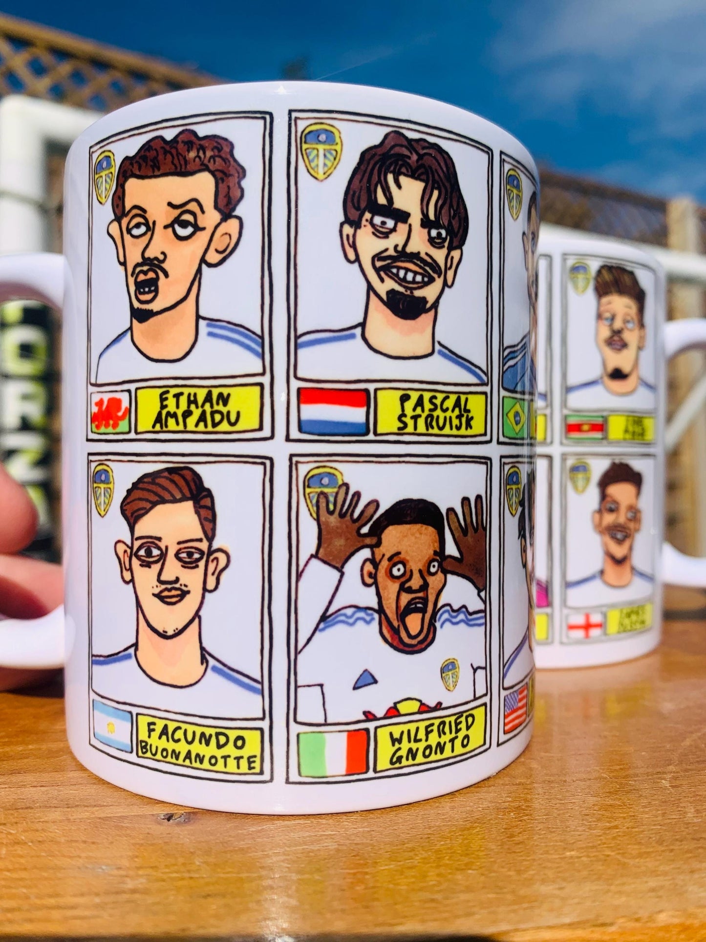 Leeds United 25/26 No Score Draws Mug Set - Set of TWO DIFFERENT 11oz Ceramic Mugs with Wonky Panini-Doodles Of Daniel Farke's PL Squad