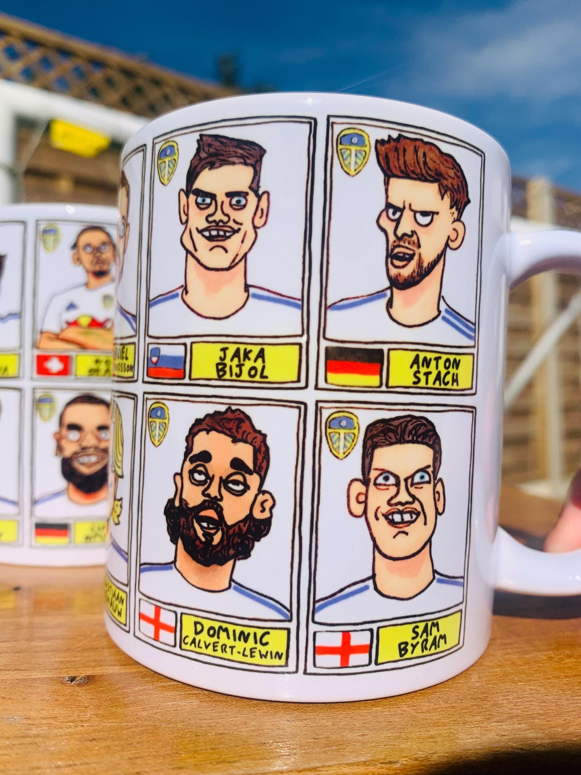 Leeds United 25/26 No Score Draws Mug Set - Set of TWO DIFFERENT 11oz Ceramic Mugs with Wonky Panini-Doodles Of Daniel Farke's PL Squad