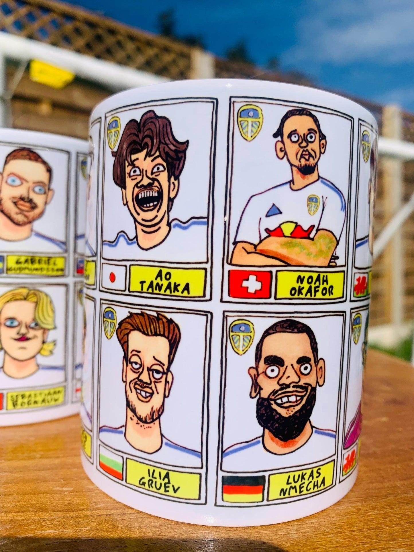 Leeds United 25/26 No Score Draws Mug Set - Set of TWO DIFFERENT 11oz Ceramic Mugs with Wonky Panini-Doodles Of Daniel Farke's PL Squad