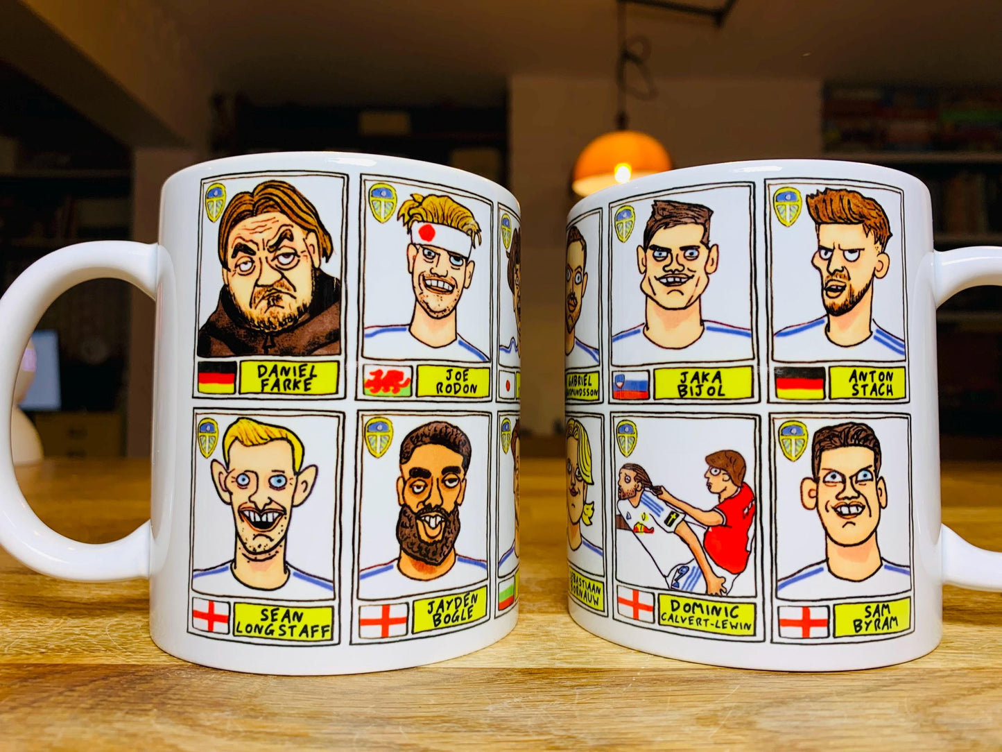 Leeds United 25/26 No Score Draws Mug Set - Set of TWO DIFFERENT 11oz Ceramic Mugs with Wonky Panini-Doodles Of Daniel Farke's PL Squad