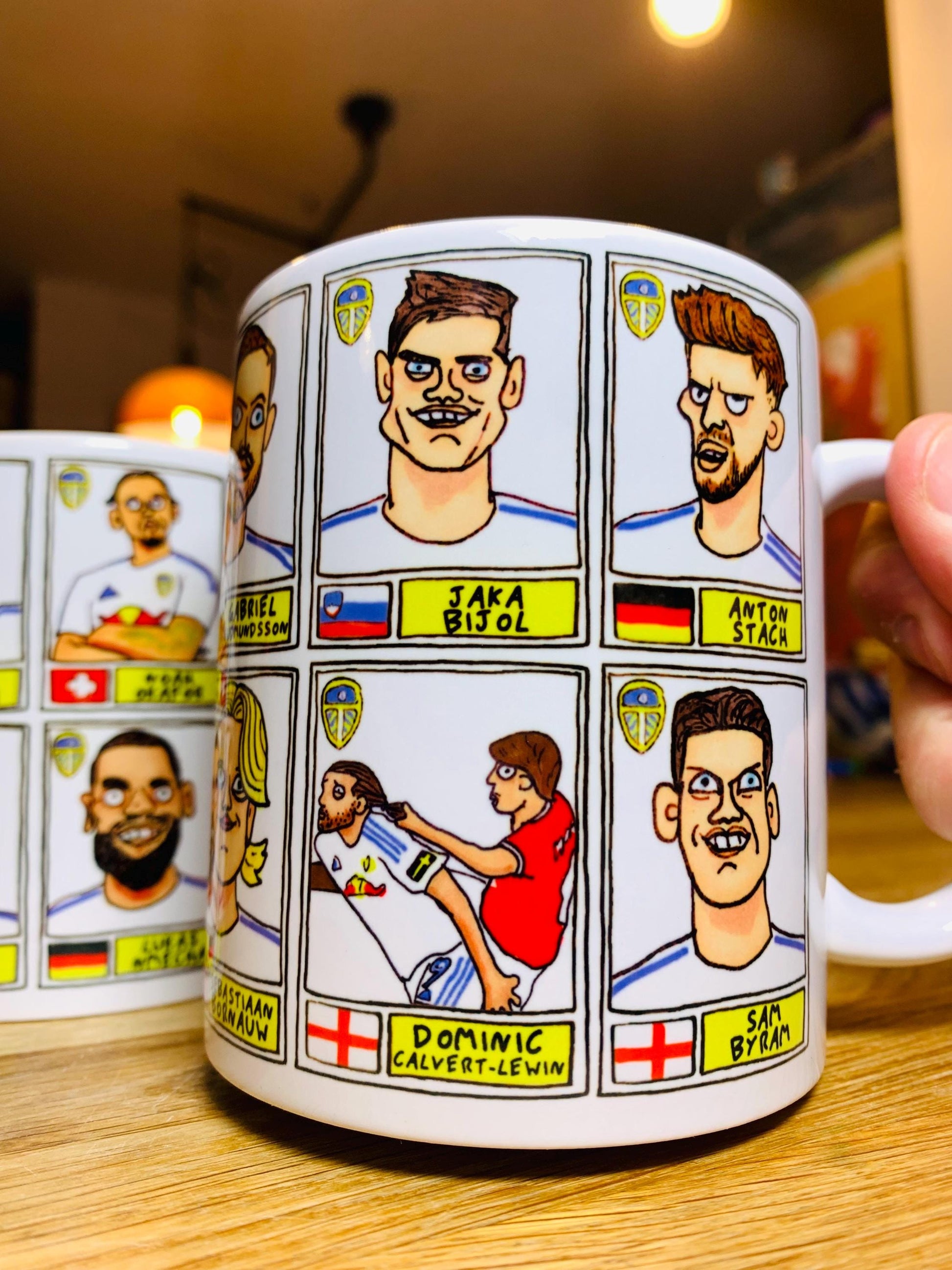 Leeds United 25/26 No Score Draws Mug Set - Set of TWO DIFFERENT 11oz Ceramic Mugs with Wonky Panini-Doodles Of Daniel Farke's PL Squad
