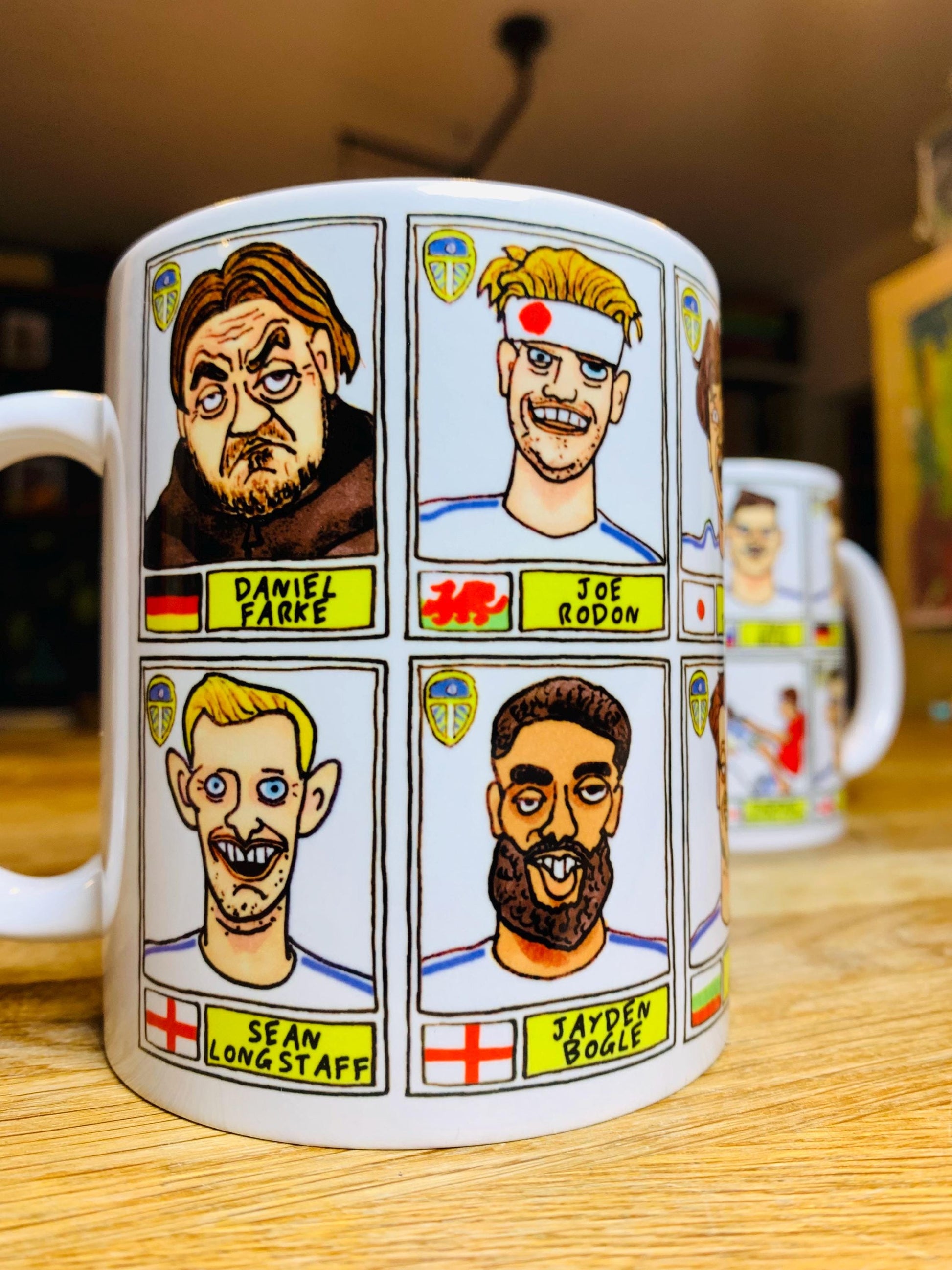 Leeds United 25/26 No Score Draws Mug Set - Set of TWO DIFFERENT 11oz Ceramic Mugs with Wonky Panini-Doodles Of Daniel Farke's PL Squad