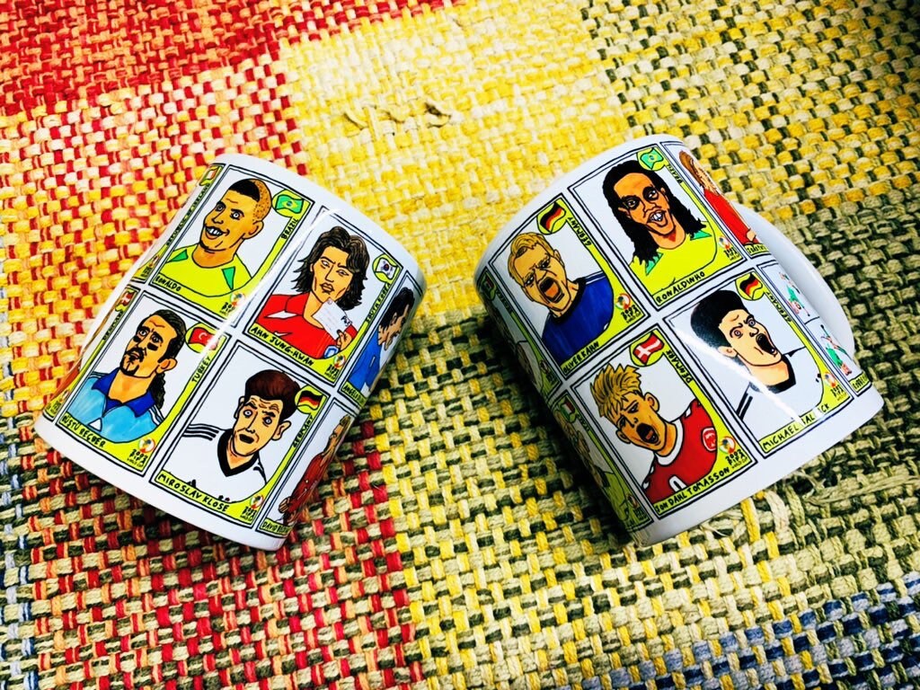 World Cup 2002 No Score Draws Mug Set - Set of TWO 11oz Ceramic Mugs with Wonky Panini sticker-style World Cup 2002 No Score Draws Doodles